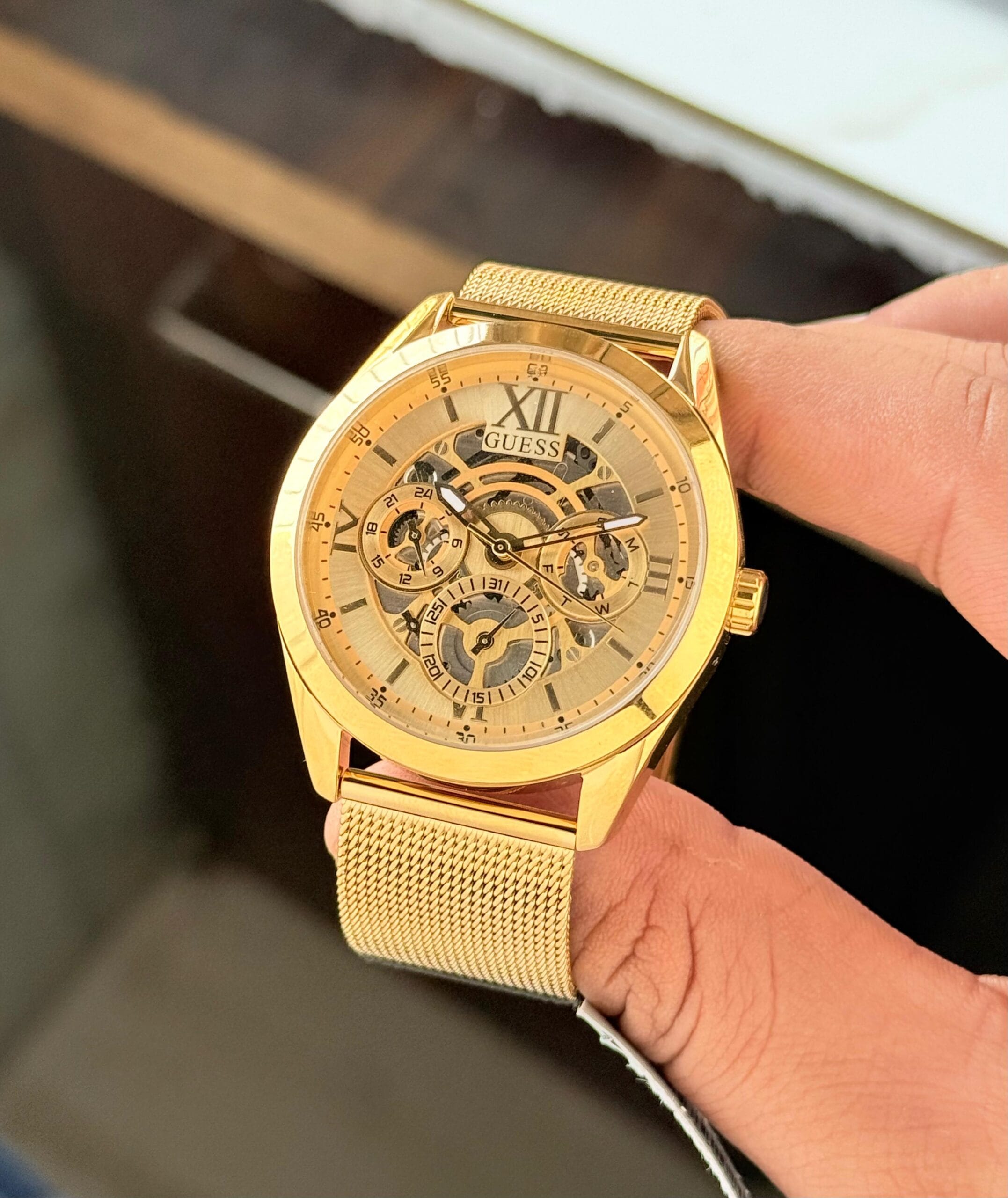 Guess GW0368G2 Tailor Chronograph Men’s Watch Full Gold Dial Black Mesh Strap Original Edition 4 Guess GW0368G2 Tailor Chronograph Men’s Watch finger view