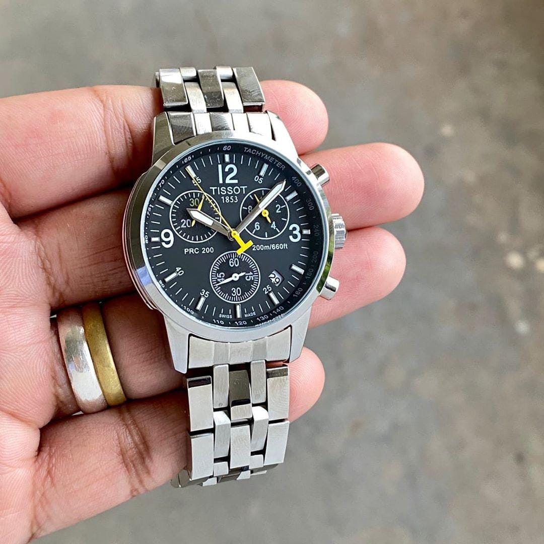 Tissot PRC 200 7AA Chronograph Men’s Premium Watch Black Dial Stainless Steel Metal Body Edition 3 Tissot PRC 200 7AA Chronograph Men’s Premium Watch Black Dial Stainless Steel Metal Body Edition hand view
