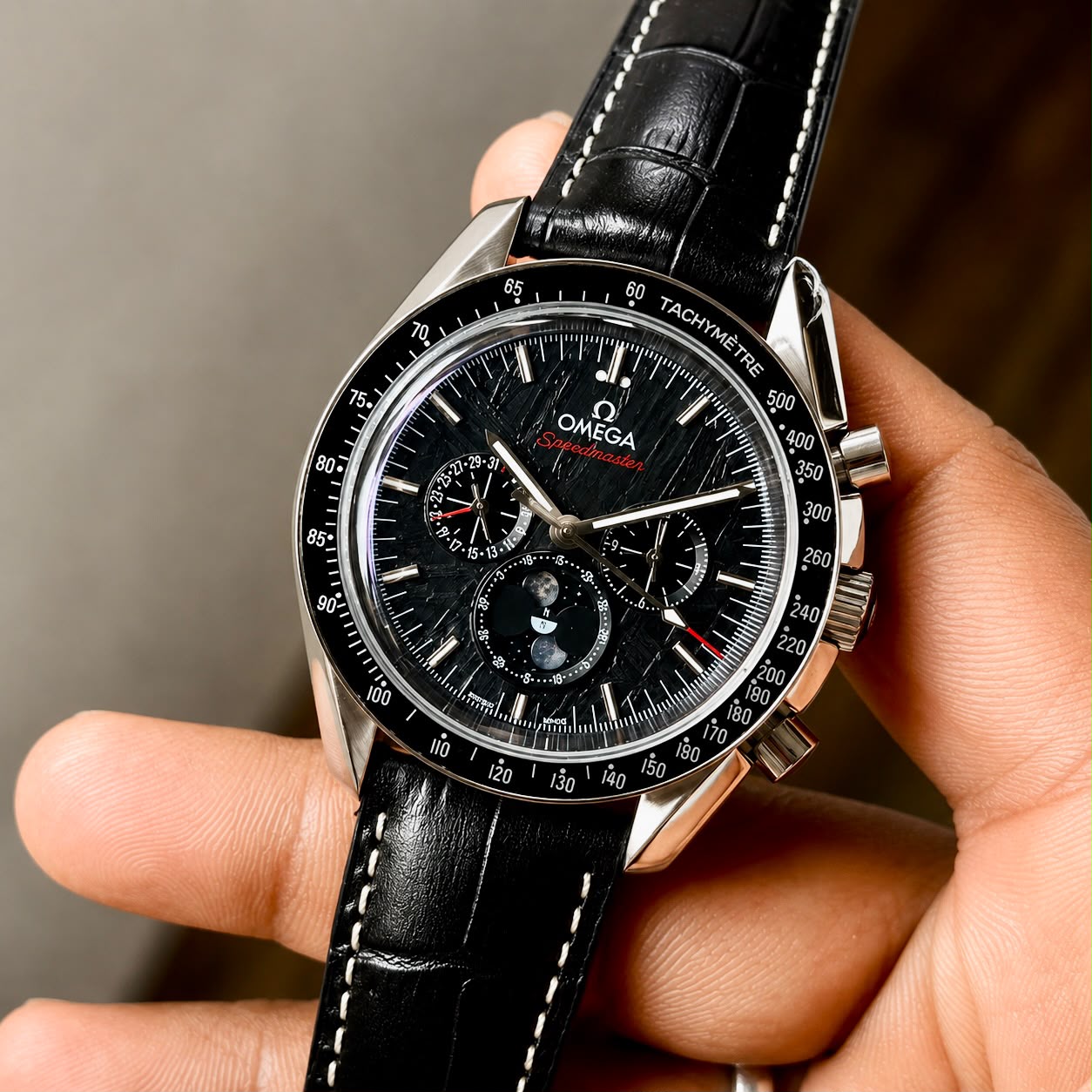 Omega Speedmaster Moonphase Automatic Men's Watch Black Meteorite Dial 3 Omega Speedmaster Moonphase Automatic angled view with leather strap